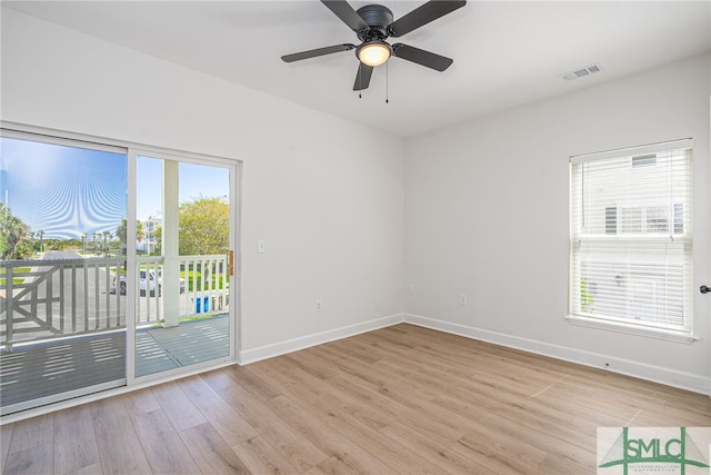 unfurnished room featuring light wood finished floors, visible vents, baseboards, and a healthy amount of sunlight