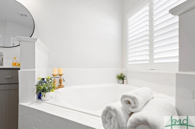 82 Rimmon Ct, Richmond Hill, GA 31324 - full bathroom featuring visible vents, a garden tub, and vanity