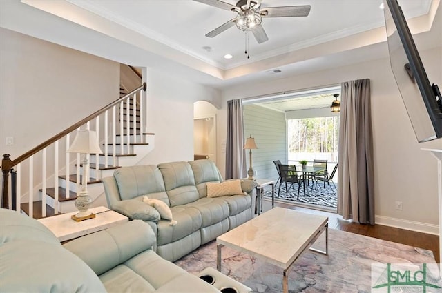 82 Rimmon Ct, Richmond Hill, GA 31324 - living area featuring wood finished floors, arched walkways, stairway, and ceiling fan