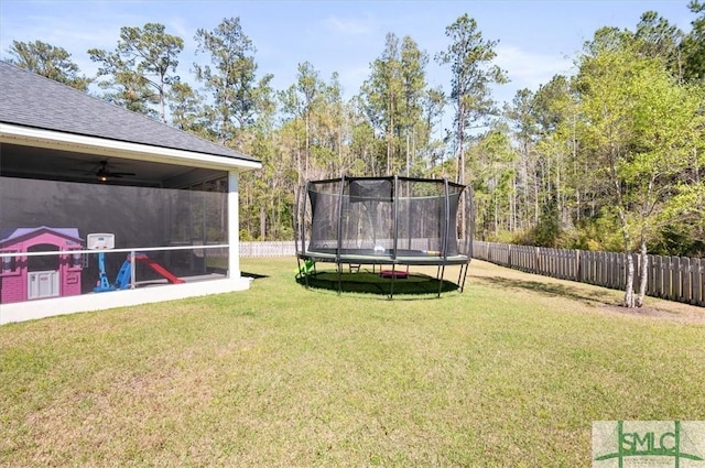 82 Rimmon Ct, Richmond Hill, GA 31324 - view of yard with a trampoline, a fenced backyard, and a sunroom