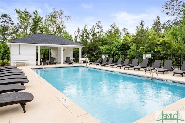 82 Rimmon Ct, Richmond Hill, GA 31324 - community pool featuring a patio area, an outdoor structure, and fence