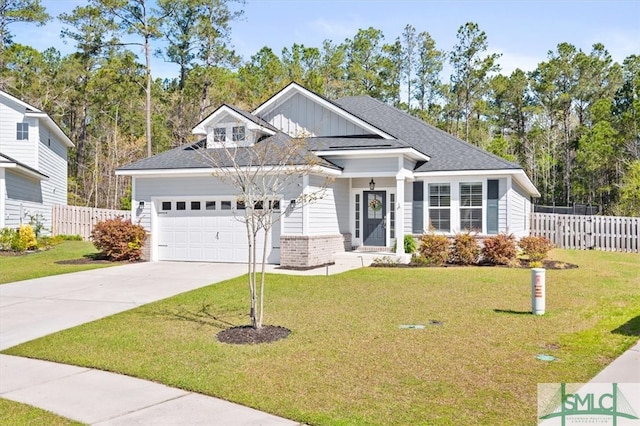 82 Rimmon Ct, Richmond Hill, GA 31324 - view of front of home featuring concrete driveway, roof with shingles, fence, an attached garage, and a front yard