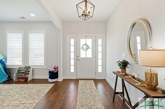 82 Rimmon Ct, Richmond Hill, GA 31324 - foyer entrance featuring dark wood-style flooring, visible vents, baseboards, recessed lighting, and a notable chandelier