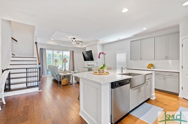 82 Rimmon Ct, Richmond Hill, GA 31324 - kitchen featuring light countertops, a sink, a ceiling fan, stainless steel dishwasher, and light wood-style flooring