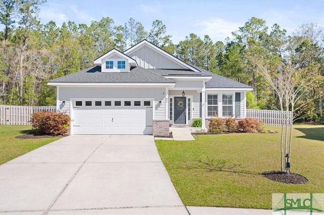 82 Rimmon Ct, Richmond Hill, GA 31324 - view of front of home featuring a front yard, roof with shingles, concrete driveway, an attached garage, and fence