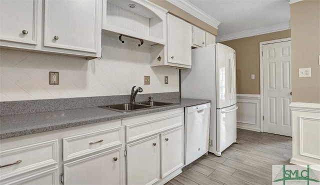 kitchen with white cabinetry, ornamental molding, a wainscoted wall, a sink, and dishwasher