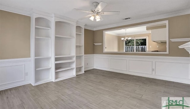 interior space featuring a wainscoted wall, visible vents, crown molding, wood tiled floor, and ceiling fan with notable chandelier