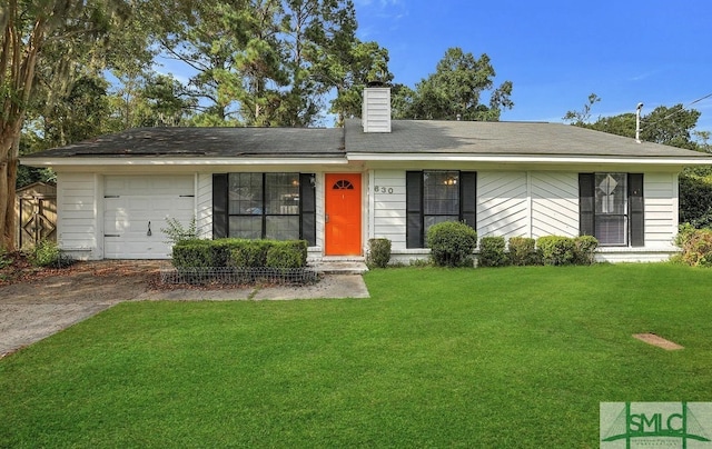 ranch-style home featuring a chimney, a garage, and a front lawn
