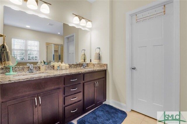 93 Bradford Pear Dr, Richmond Hill, GA 31324 - bathroom featuring a stall shower, tile patterned flooring, double vanity, and baseboards