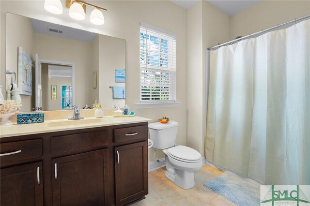 93 Bradford Pear Dr, Richmond Hill, GA 31324 - full bath with vanity, toilet, tile patterned flooring, curtained shower, and baseboards