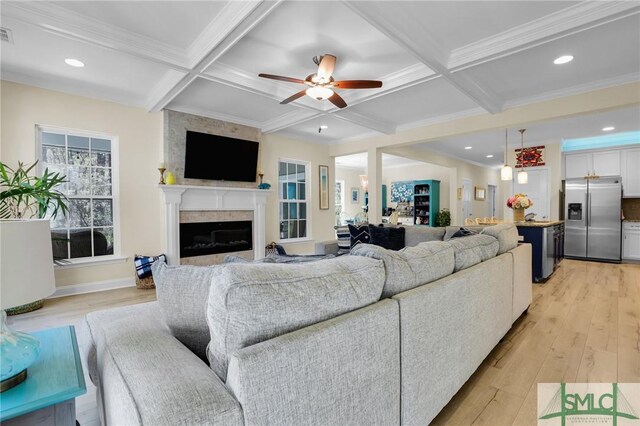 93 Bradford Pear Dr, Richmond Hill, GA 31324 - living room with a fireplace, coffered ceiling, light wood-style flooring, beam ceiling, and a ceiling fan