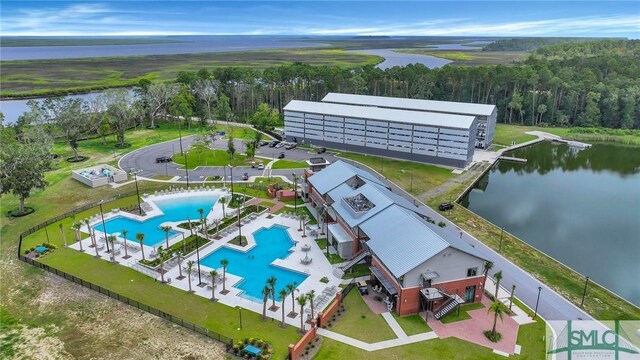 93 Bradford Pear Dr, Richmond Hill, GA 31324 - bird's eye view of a pool area, a large body of water, and a heavily wooded area
