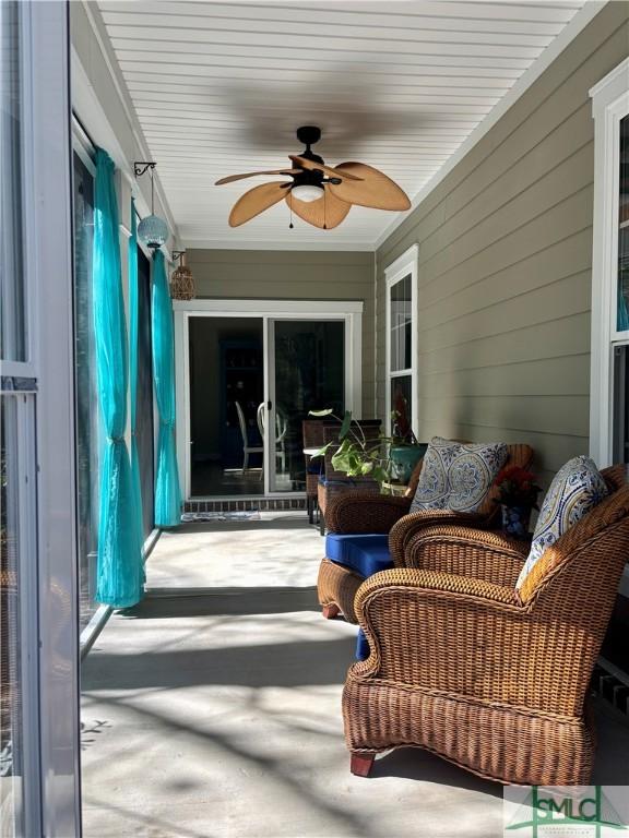 93 Bradford Pear Dr, Richmond Hill, GA 31324 - sunroom with a ceiling fan and wood walls