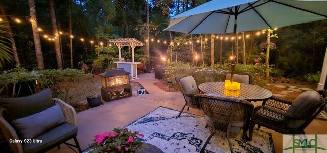 93 Bradford Pear Dr, Richmond Hill, GA 31324 - patio at twilight featuring a patio area and outdoor dining area