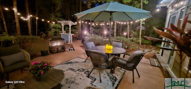93 Bradford Pear Dr, Richmond Hill, GA 31324 - patio at night featuring a patio area and outdoor dining space