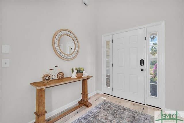 entryway featuring baseboards and wood finished floors