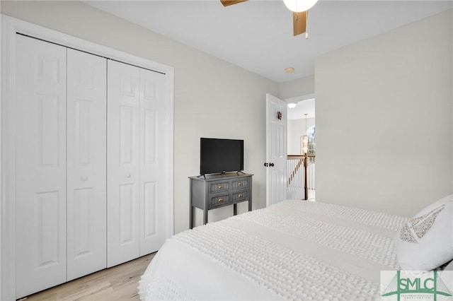 bedroom featuring a closet, ceiling fan, and light wood finished floors