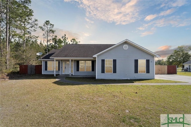 60 Lanier Rd NE, Ludowici, GA 31316 - ranch-style house with fence, roof with shingles, and a front yard