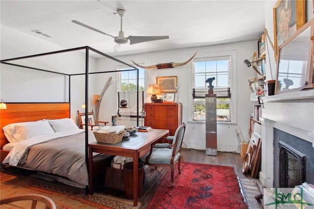 24 W Taylor St, Savannah, GA 31401 - bedroom with a glass covered fireplace, wood finished floors, and visible vents