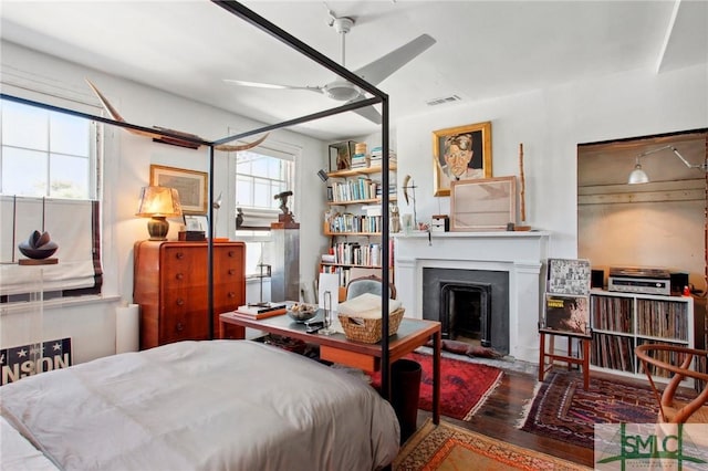 24 W Taylor St, Savannah, GA 31401 - bedroom featuring visible vents, wood finished floors, and a fireplace with flush hearth