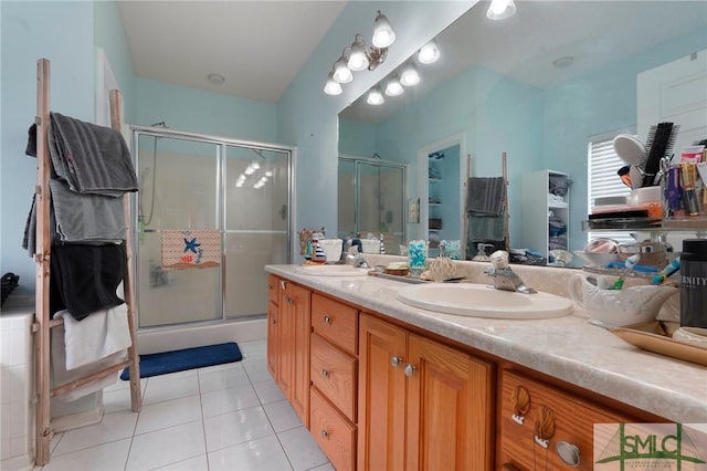 full bath with tile patterned flooring, a sink, double vanity, and a stall shower