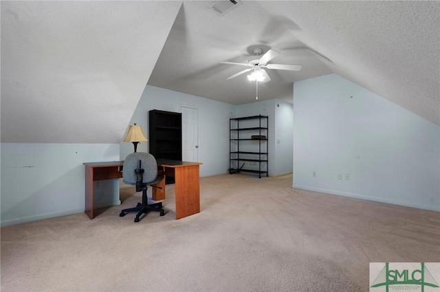 office space featuring a textured ceiling, visible vents, ceiling fan, lofted ceiling, and carpet floors