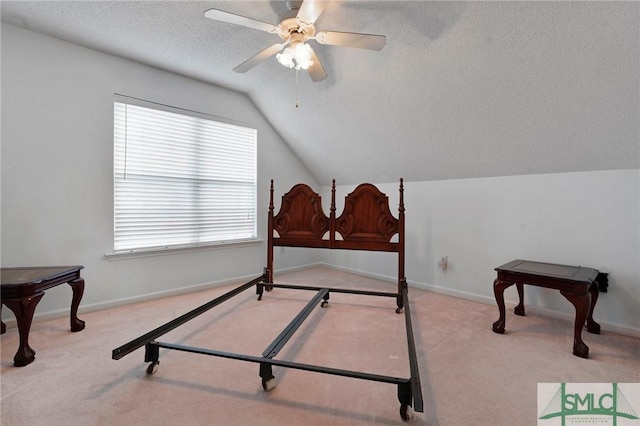 bedroom featuring baseboards, carpet floors, a textured ceiling, and vaulted ceiling
