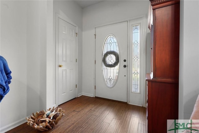 foyer entrance with baseboards and wood finished floors