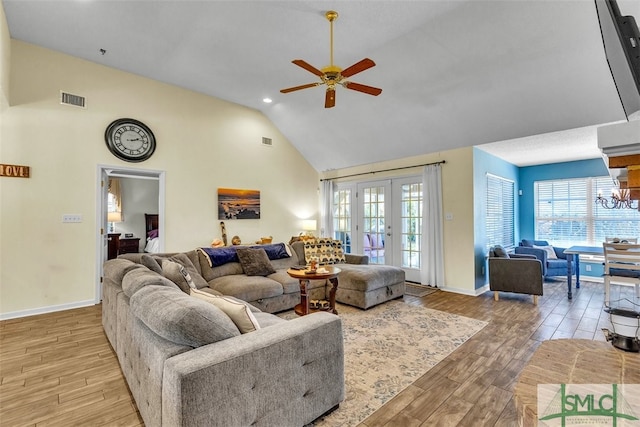 living area featuring light wood finished floors, healthy amount of natural light, ceiling fan, high vaulted ceiling, and recessed lighting