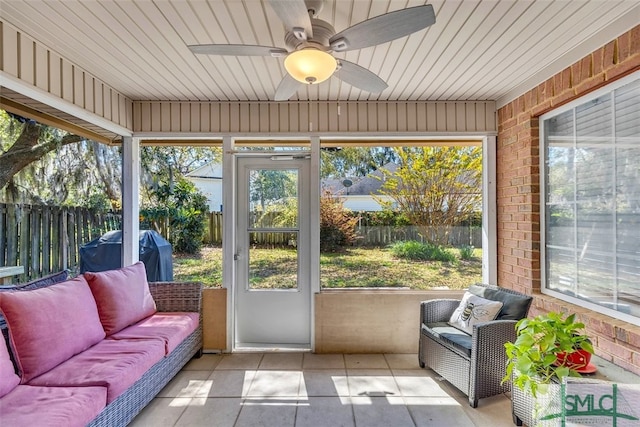 sunroom / solarium featuring an outdoor hangout area, a ceiling fan, and plenty of natural light
