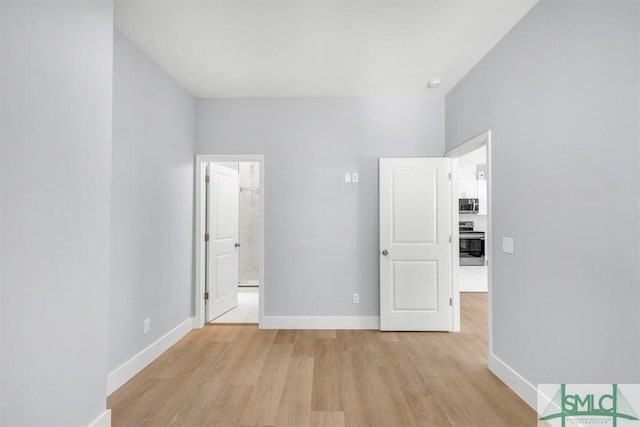 unfurnished bedroom featuring baseboards and light wood-style floors