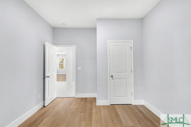 unfurnished bedroom with baseboards and light wood-style floors