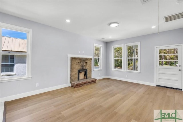 unfurnished living room with attic access, light wood-style flooring, baseboards, visible vents, and recessed lighting