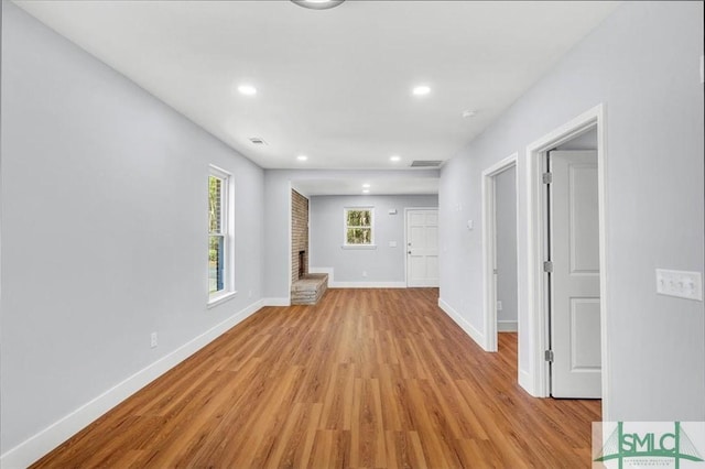interior space featuring recessed lighting, baseboards, and light wood-type flooring