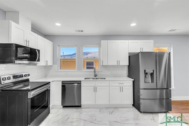 kitchen featuring light countertops, a sink, visible vents, white cabinets, and appliances with stainless steel finishes