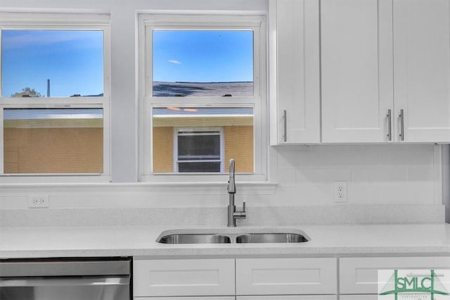 kitchen featuring white cabinetry, a sink, light countertops, and dishwasher