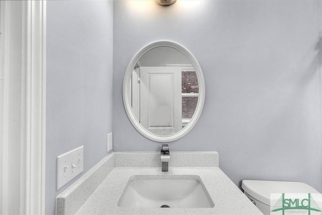 bathroom with toilet and vanity