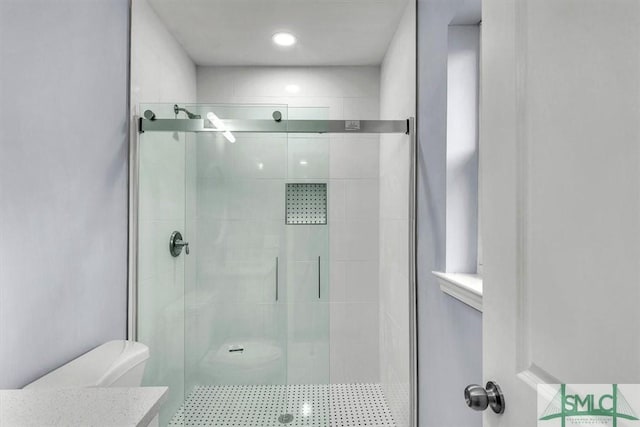 full bath featuring a shower stall, toilet, and vanity
