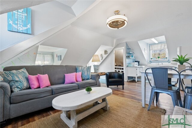 living room with lofted ceiling and wood finished floors