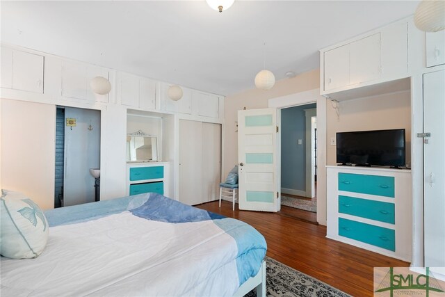bedroom with a closet and dark wood finished floors