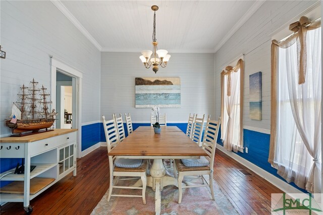 dining room featuring baseboards, a notable chandelier, ornamental molding, and dark wood-type flooring
