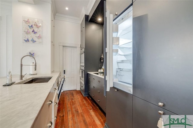 909 Howard St, Savannah, GA 31401 - kitchen featuring light countertops, crown molding, oven, a sink, and dark wood-style floors