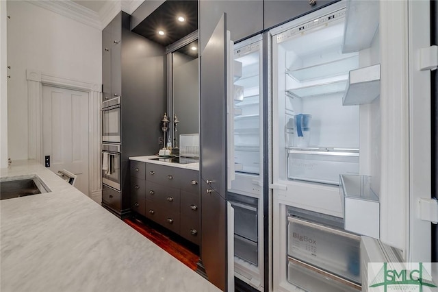 909 Howard St, Savannah, GA 31401 - kitchen with light countertops, black electric stovetop, ornamental molding, and dark wood finished floors
