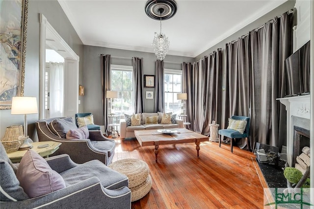 909 Howard St, Savannah, GA 31401 - living room with a fireplace with flush hearth, ornamental molding, an inviting chandelier, and hardwood / wood-style flooring