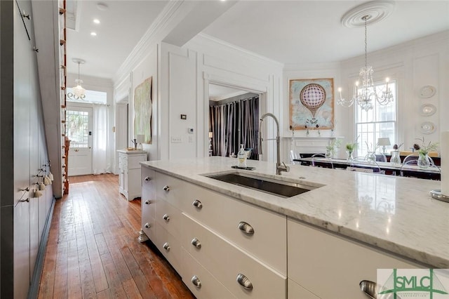 909 Howard St, Savannah, GA 31401 - bathroom with wood-type flooring, vanity, ornamental molding, and a chandelier