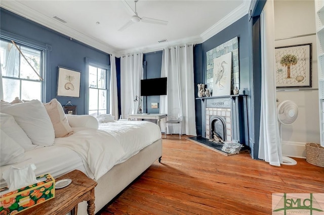 909 Howard St, Savannah, GA 31401 - bedroom featuring multiple windows, a fireplace, wood finished floors, and ornamental molding