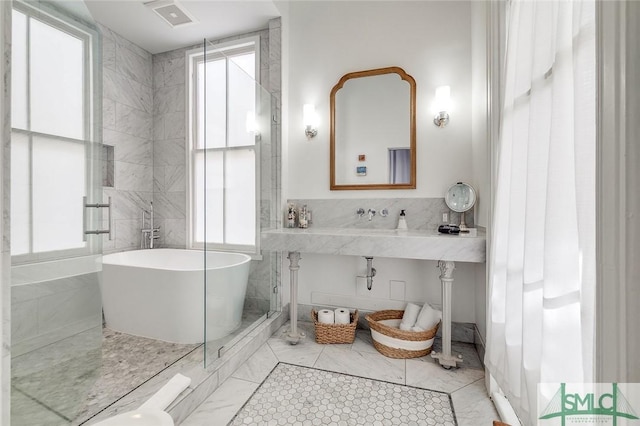 909 Howard St, Savannah, GA 31401 - full bathroom with a soaking tub, tile walls, and visible vents