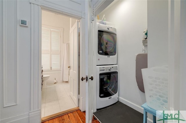 909 Howard St, Savannah, GA 31401 - clothes washing area with stacked washer / dryer, laundry area, and light tile patterned floors