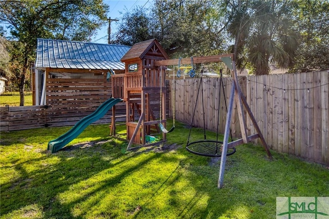 view of play area featuring a lawn and a fenced backyard