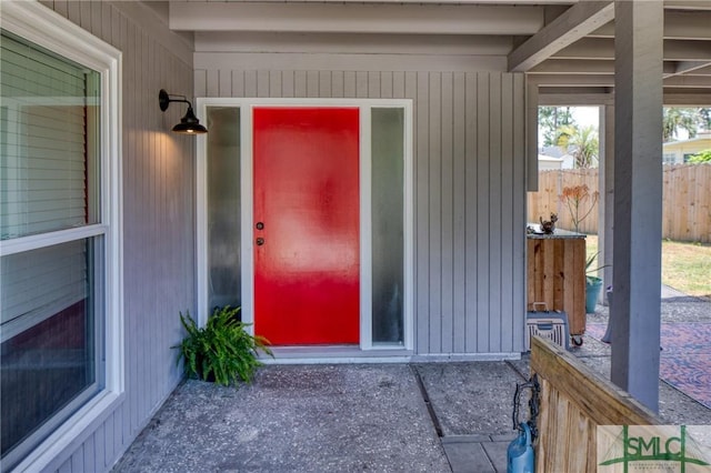 view of exterior entry with fence